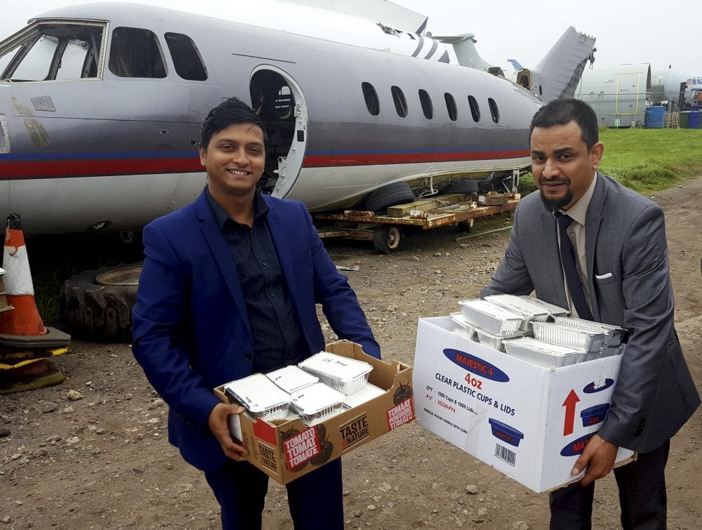 Shajahan Chowdhury (R) and Adnan Ahmed (L) delivering curry as payment for the plane. An indian restaurant boss with dreams of being a pilot has finally got his very own plane - after swapping it for 500 curries and 1,000 poppadoms. See ROSS PARRY story RPYCURRY. Shajahan Chowdhury bartered with the spicy fare to get his hands on the shell of 49-foot-long Hawker Siddeley HS125 jet which he now plans to turn into a restaurant. Aviation salvage company GJD Services were only too happy to swap the ex-charter jet for 150 vindaloos, 150 Bombay Aloos, 100 onion bhajis and a cockpit full of poppadoms. A promise of a further 200 tasty treats will follow on request. Mr Chowdhury , who is originally from Bangladesh, yearned to be a pilot when he was a young boy, is hoping to revamp to he plane so it looks like a private jet. As as chef he has worked all round the country, and during his career he has cooked for stars such as Cliff Richard, the Spice Girls. Aswad, Soul 2 Soul and Chaka Khan.
