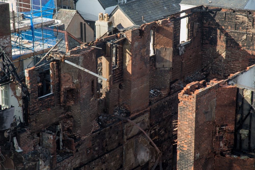 The damage to the Royal Clarence Hotel in Exeter can be seen from a fire fighters lift. 31 October 2016.  See SWNS story SWFIRE: A fire that wrecked England's oldest hotel has completely destroyed the 18th century building. The front of the hotel collapsed in the early hours and an extra eight fire engines rushed to the scene of the the front of the historic Royal Clarence Hotel in Exeter, Devon. People were advised by the emergency services to stay well away from the city centre as it was believed the hotel could completely collapse. An Exeter City Council chief, Karime Hassan, said: "Key message this morning - please keep away from Cathedral Yard area and let emergency services do their job."