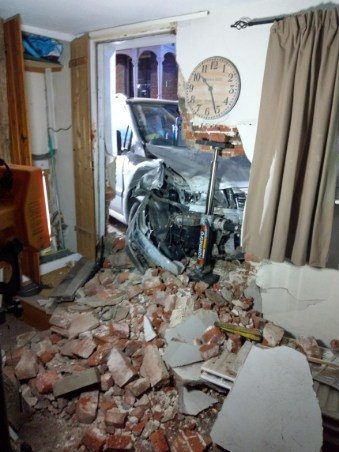 Pics – Car wedged into house after it smashed through the front door