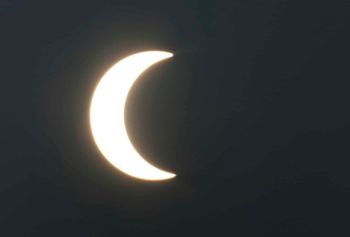 A partial solar eclipse is seen from Karachi, Pakistan, Thursday, Dec. 26, 2019. The last solar eclipse of 2019 was witnessed in Pakistan along with several other countries. (AP Photo/Fareed Khan)
