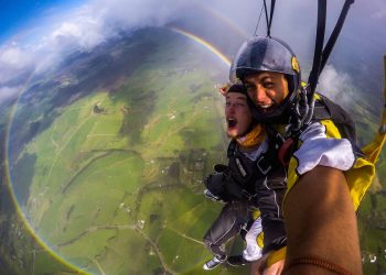 Anthony Killeen gets the thrill of his life as he skydives over a 360 degree rainbow. See SWNS story SWRAINBOW;  The British expat was on his first skydive with an instructor over New Zealand's Bay of Islands when he spotted the perfect circles of colour. Killeen said the rainbow kept its form until it was time to descend and land. "All the instructors said they hadn't seen that before either - some had seen it from the plane, but never whilst diving."