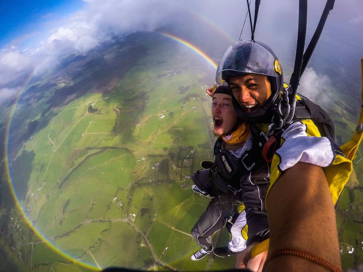 Anthony Killeen gets the thrill of his life as he skydives over a 360 degree rainbow. See SWNS story SWRAINBOW;  The British expat was on his first skydive with an instructor over New Zealand's Bay of Islands when he spotted the perfect circles of colour. Killeen said the rainbow kept its form until it was time to descend and land. "All the instructors said they hadn't seen that before either - some had seen it from the plane, but never whilst diving."