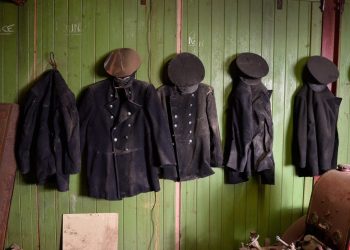 Old uniforms are still hanging on the walls.  These remarkable pictures show a fire station which was left untouched for more than 60 years before it was discovered in the cellar of an old Co Op factory.  See NTI story NTIFIRE.  The secret fire station is complete with 1920s firefighting equipment, pumps, uniforms and coiled hoses.  A half-drunk bottle of lemonade and exercise programmes were also found in the cellar of the former Co Op factory in Dudley, West Mids.  Staff at shopfitting company The Allan Nuttall Partnership, which is now based in the building, heard rumours of a hidden fire station but dismissed it as an "urban myth".  But when marketing manager Anna Bramford dug out some keys she was astonished to find fire regalia and pumps dating back to the 1920s.