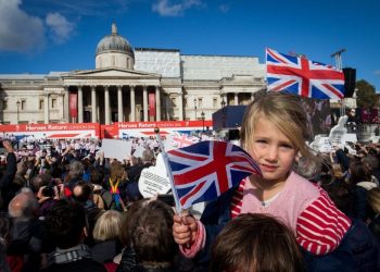 Rosie Chamberlain, 3, waves a flag as thousands of people pack into Trafalgar square for the London Heroes return event for the Great Britain Olympic team, London. 18 October 2016.