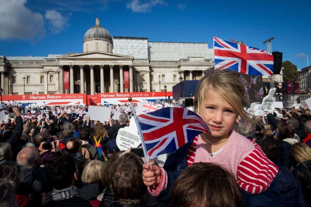 Rosie Chamberlain, 3, waves a flag as thousands of people pack into Trafalgar square for the London Heroes return event for the Great Britain Olympic team, London. 18 October 2016.