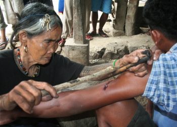 Meet the world's oldest tattooist whose tribal inkings are 20 TIMES more painful than normal body art. See SWNS story SWTATT;  Filipino spinster Whang-od, 97, dedicated her life to tattooing villagers since she learned the ancient practice aged just ten. She uses charcoal and water to make the ink, which is then hammered inside the skin using a THORN from a tree. Hundreds of 'tattoo tourists' a year now trek to her remote mountain village in Kalinga province, some ten hours from the Philippines capital Manilla, for one of her ancient designs.