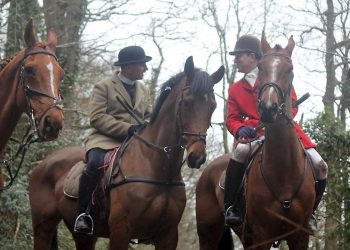 Rev Neil Patterson in a beige hunting jacket (left) with Major Patrick Darling, former High Sheriff of Herefordshire on February 20, 2016 when the Three Counties Hunt Saboteurs claim he was at a meet of South Herefordshire Hunt in Brockhampton. See SWNS story SWHUNT; A campaign has been launched calling for a vicar to be sacked after footage emerged which appears to show him at a hunt meet - at his parish CHURCH. The Rev Neil Patterson, 36, has been accused of lacking Christian values after photos surfaced of him on a horse with the notorious South Herefordshire Hunt. The Hunt is being investigated for animal cruelty over footage was released in June which appears to show live fox cubs being thrown to a pack of hounds to savage. Five people have been arrested so far this summer as part of the inquiry.