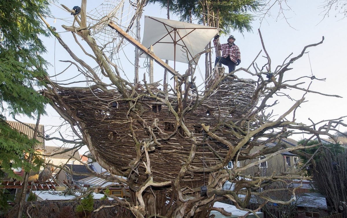 Fife-based sculptor and artist Denis Carbonaro with his Bark Park, larger-than-life creations including a woolly mammoth in the front garden, a huge spider crawling up the house, or a galleon ship in the garden made from foraged tree bark and foliage. Jan 26 2017 . See Centre Press story CPSHIP; A wacky sculptor has turned his property into a tourist attraction after creating an impressive galleon ship, nestled in trees at the back of his garden. Denis Carbonaro, 48, quit his job three years ago to return to his love of art, and soon turned to working as a sculptor. And now he hopes his popular garden in Dalgety Bay, Fife, can lay the future for a dedicated sculpture park. Denis, a former web designer originally from the Italian island of Sicily, has become famous in the area for his wooden sculptures of a mammoth and a spider. He uses only recycled wood in his art, often in the form of fallen branches which he finds in the area.