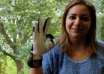 Hadeel Ayoub wearing the smart glove which translates sign language - into speech. See National copy NNGLOVE: A savvy student has designed a 'smart glove' which translates sign language - into speech. PhD student Hadeel Ayoub designed the BrightSign to help people with speech disabilities communicate without needing an interpreter. Hadeel, who specialises in digital and software design at Goldsmiths University, has been working on the BrightSign for the past two years as part of her PhD project. She said: "What it does is it translates sign language to text into speech in real time to allow people with speech disabilities to communicate with the general public without having to have an interpreter or someone to communicate on their behalf.