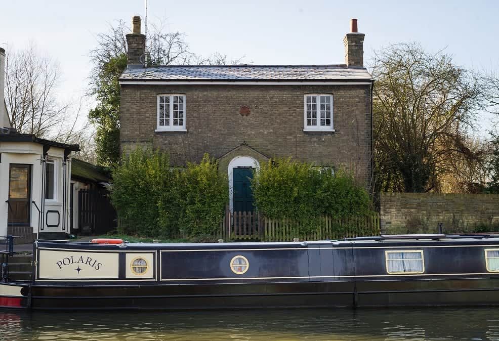 Ferry House situated on the bank of the river cam in Cambridge next to the Fort st George pub and close to the Mihelin star restaurant Midsummer house. See SWNS copy SWCOUNCIL:A riverside home with a Michelin-starred restaurant on its doorstep is set to become one of the UK’s most expensive COUNCIL HOUSES after it was put on the market for £750,000.Ferry House is a three-bedroom 'doer upper', which sits on the bank of the River Cam in Cambridge. It is in heart of the historic city centre and within half-a-mile of a mixture of ancient and modern buildings, colleges and shops.