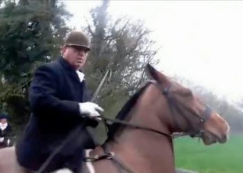 The moment a Huntsman allegedly whips female Sabateur. See SWNS story SWHUNT; Body-camera footage from the West Midlands Hunt Sabateurs reveals a clash with the Atherstone Hunt on a footpath. The protesters claim the horsemen were backing into the sabs before one rider shouts: "It's dangerous here. Come on, be fair." Then a loud thump is heard followed by a scream before the riding man is caught on camera with his riding crop up near the injured woman hunched over in pain. Sabs claim the woman was taken to hospital following the clash in Shackerstone, Leicestershire, on Saturday for a large gash in her head to be glued.