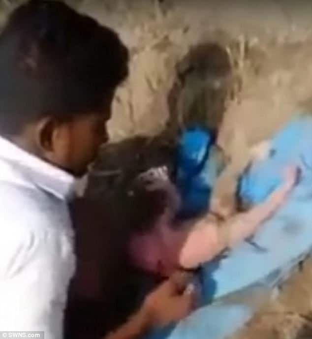 Watch – Newly born baby girl BURIED ALIVE rescued after her feet are seen sticking up