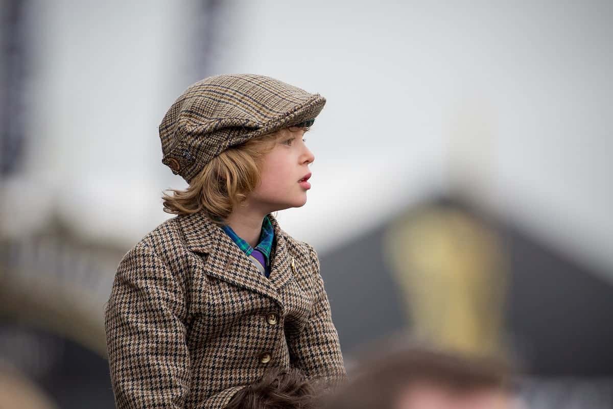 A young boy watches the third race of the day at the Gold Cup, the final day of the horse racing, at the Cheltenham Festival 2017, which is also St Patrick's Day. March 17 2017.