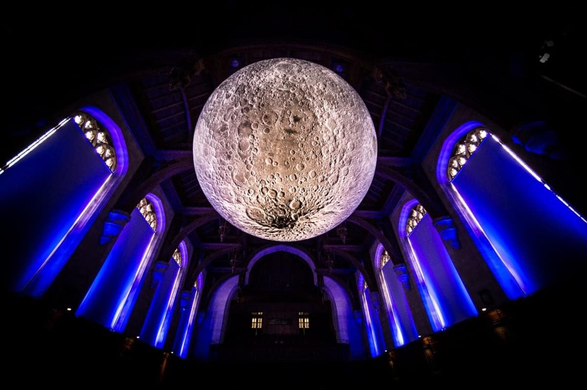 Artist Luke Jerram with his installation, Museum of the Moon, in the University of Bristol Great Hall, Wills Memorial Building, Bristol. See SWNS story SWMOON; Measuring seven metres in diameter, Luke’s Moon features detailed NASA imagery of the lunar surface. Each centimetre on his moon represents 5km on the surface of the Earth's largest natural satellite. The installation in the Great Hall is part of the Moon’s international tour in which it is presented in different ways, both indoors and outdoors, altering the experience of the artwork for different audiences worldwide.