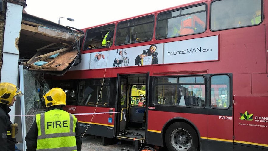 Two trapped after a double decker bus smashed into a shop 