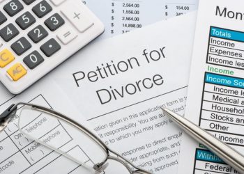 Close up of a petition for divorce with pen and calculator