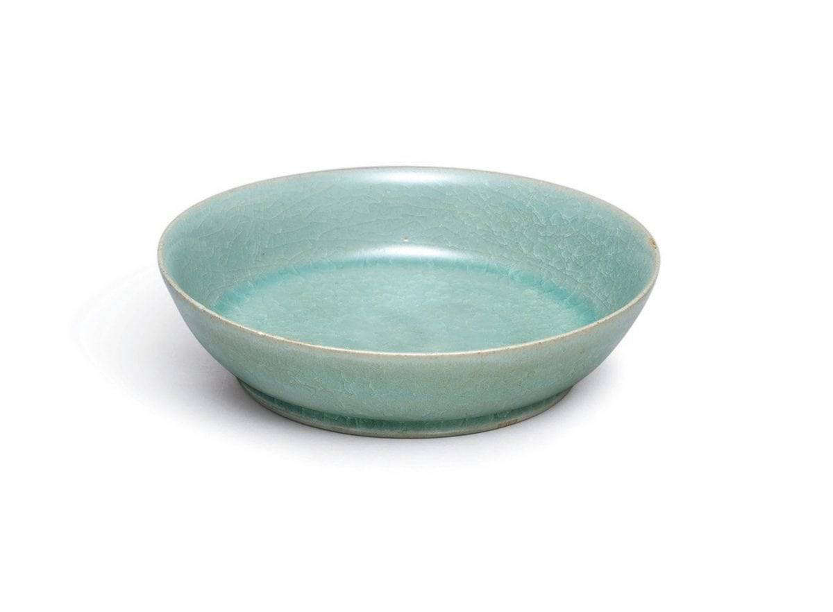 A small but highly-important ceramic dish from Imperial China is expected to sell for more than £10 MILLION at auction. See SWNS story SWBOWL; The brush washer is around 1,000 years old and was commissioned by the imperial court during the Song dynasty. And it was made by Ru guanyao, which is one of the most revered of the Five Great Kilns used during this period. The brush washer, which has a diameter of just 13cm, has a glowing, intense blue-green glaze and 'ice crackle' pattern. It is most likely the dish was made between 1086 and 1106 and it is extraordinarily rare for a Ru vessel to be sold at auction. There are thought to be just 87 pieces of Ru official ware in existence and only six have been sold publicly since 1940. The brush washer is one of only four in private hands and Sothebys will auction it in Hong Kong on October 3.