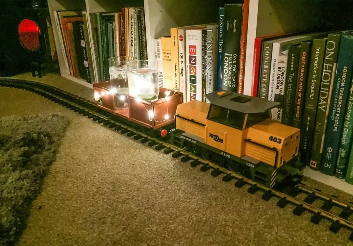 Flying Scotchman: Train buff uses model rail to distribute drinks at his Christmas party