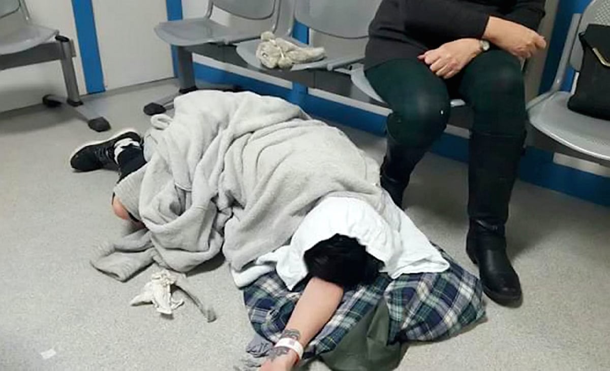 Shocking pictures of 22-year-old woman lying in agony on hospital floor after beds crisis