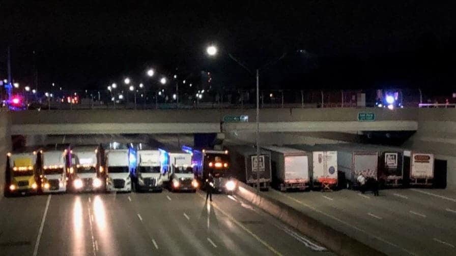 Watch 13 trucks line up under a bridge to stop suicide