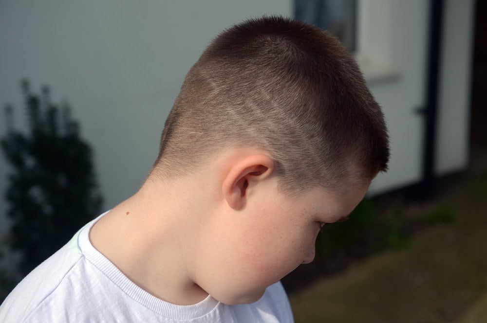 7yo boy banned from playground over his ‘inappropriate’ hair – at school where Head sports a PINK do