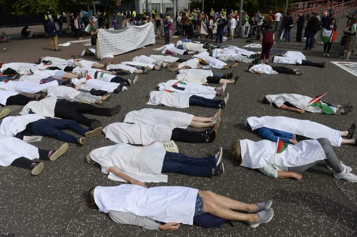 Hundreds of protesters gather to rally against an arms dealers conference