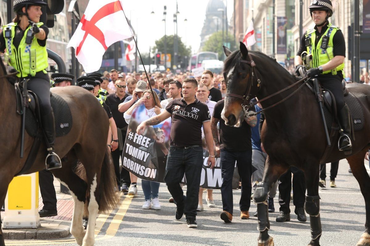 Around 400 Tommy Robinson supporters turned marched today to protest the jailing of the English Defence League (EDL) founder. One supporter threw a red flare on top of the court building and a Dr Pepper bottle was thrown at a police officer. Despite Tommy Robinson admitting contempt of court last Friday in breaching a temporary reporting restriction put in place to allow related cases not to be jepoardised, 400 of his fans brandished '#FreeTommy' placards.