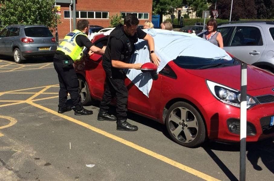 Police officers broke into a blazing hot car to free two sweltering dogs