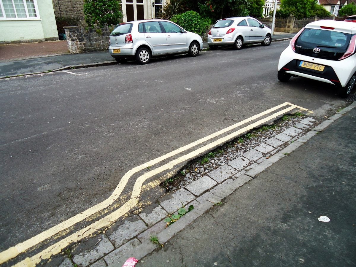 Double yellow lines painted around pothole to avoid extra work