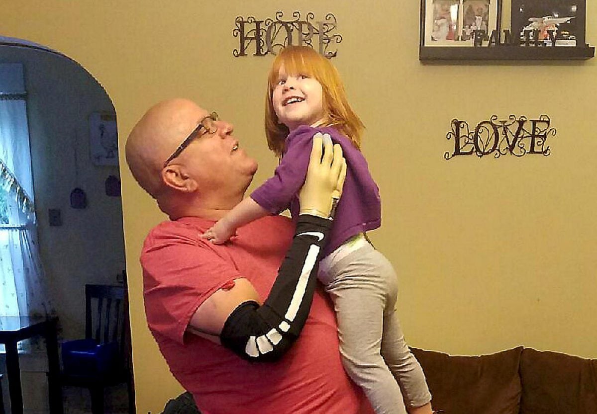 New prosthetic limbs helps a man to actually feel picking up his grand daughter for first time