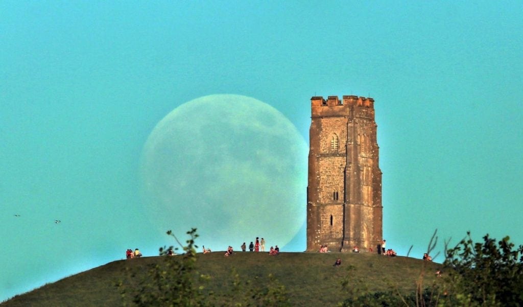 Strawberry Moon rising over Glastonbury Tor in the evening when it was