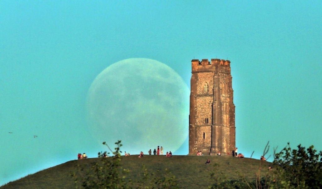 Strawberry Moon rising over Glastonbury Tor in the evening when it was