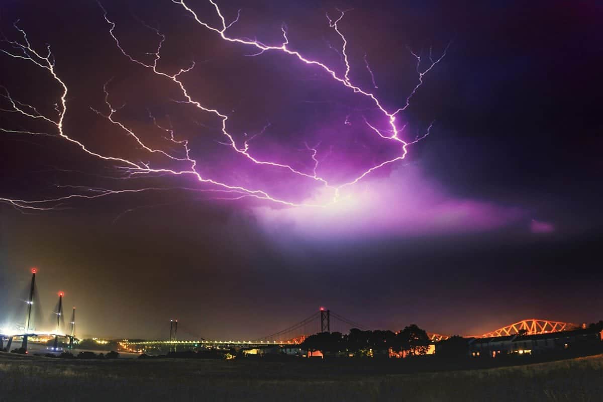 An amazing image of fork lightning above the three bridges over the Firth of Forth