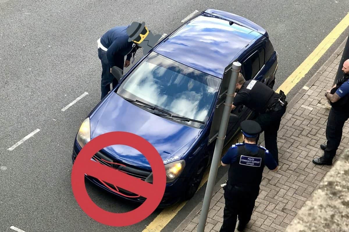 Driver caught by cops rolling a spliff while sat at a bus stop outside a POLICE STATION