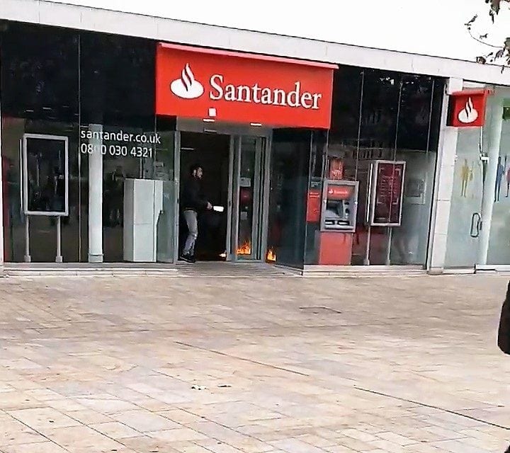 Watch – Moment a crazed man sets fire to a bank in a busy city centre