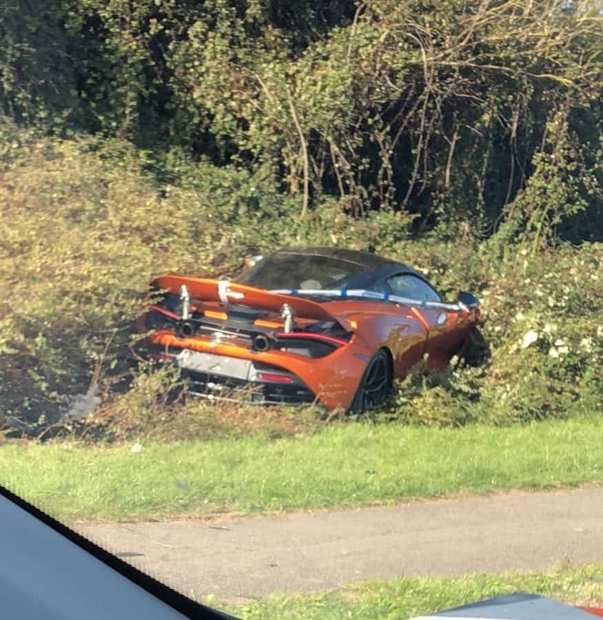 Pics shows McLaren supercar worth £250,000 buried in bushes alongside busy road