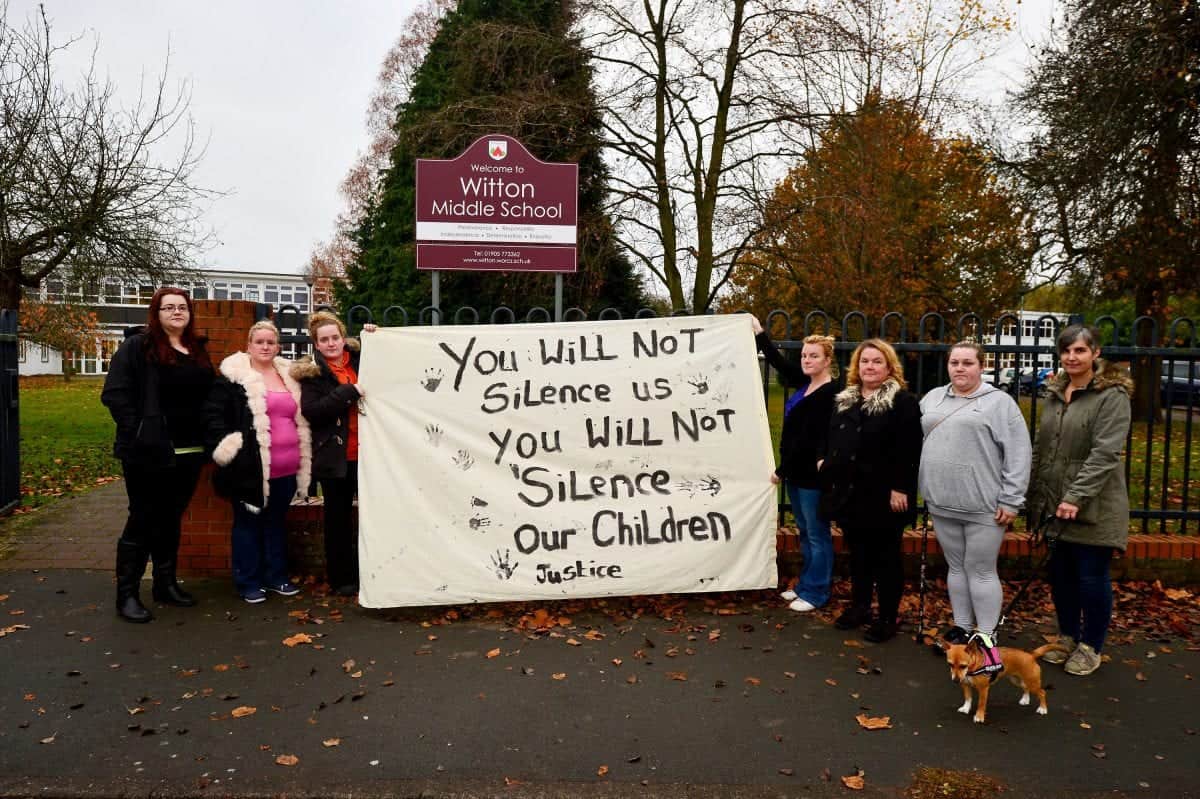 Angry parents gather outside school to protest treatment of ten-year-old girl who attempted suicide after bullying