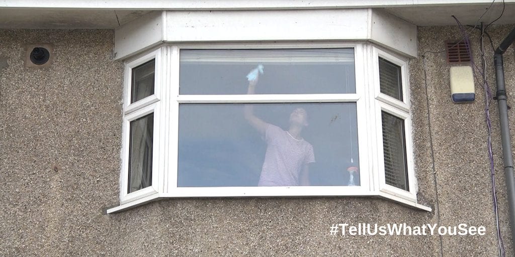 Police release photo of woman cleaning windows to educate public on indicators of modern day slavery