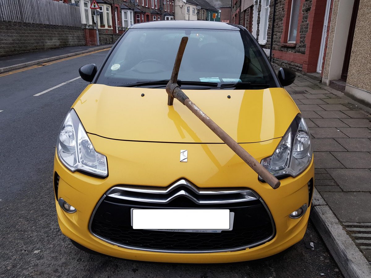 Horrifying picture shows an PICKAXE hammered into the bonnet of a car