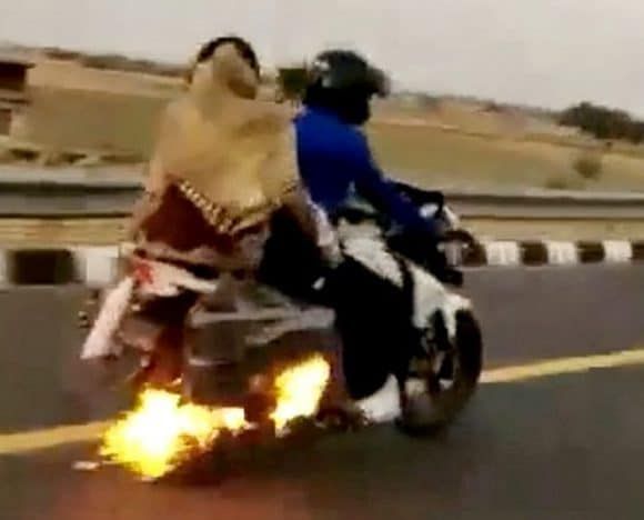 Shocking footage shows moment driver saves motorbiker unaware his bike is on fire