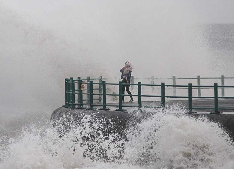 Woman holding baby smashed by massive wave as she stood on edge of pier