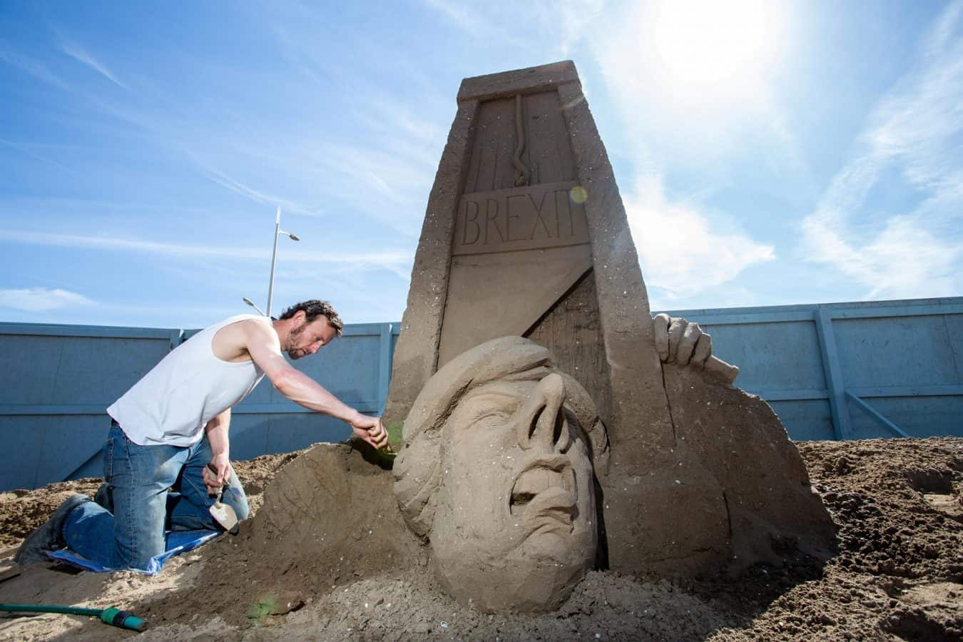 Sand artist creates giant sculpture of Theresa May losing her head under Brexit guillotine