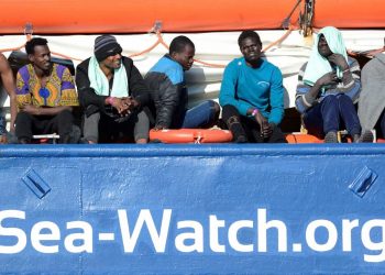 FILE PHOTO: Migrants rest on board the Sea Watch 3 off the coast of Siracusa, Italy, January 27, 2019. REUTERS/Guglielmo Mangiapane/File Photo
