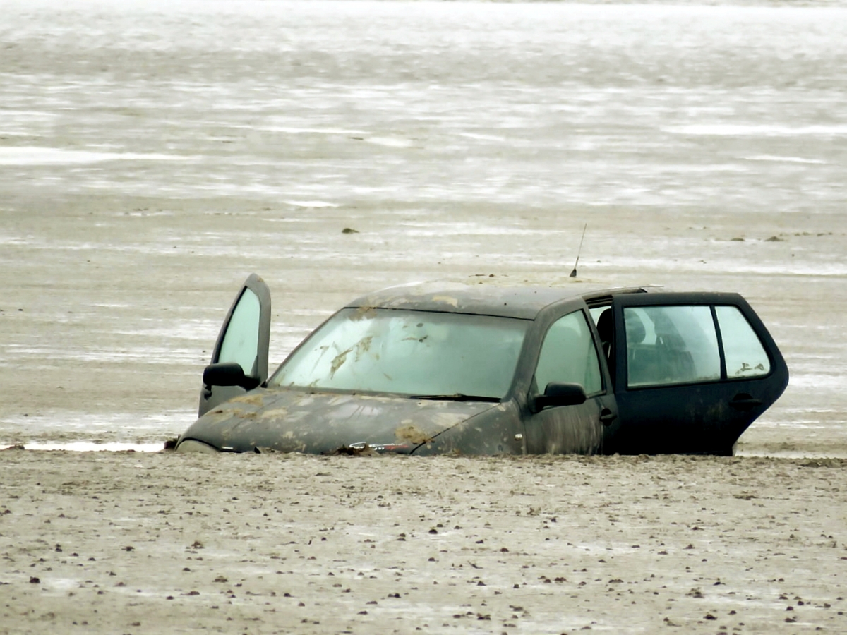 Car becomes unlikely tourist attraction at beach – after spending the six days stuck in MUD