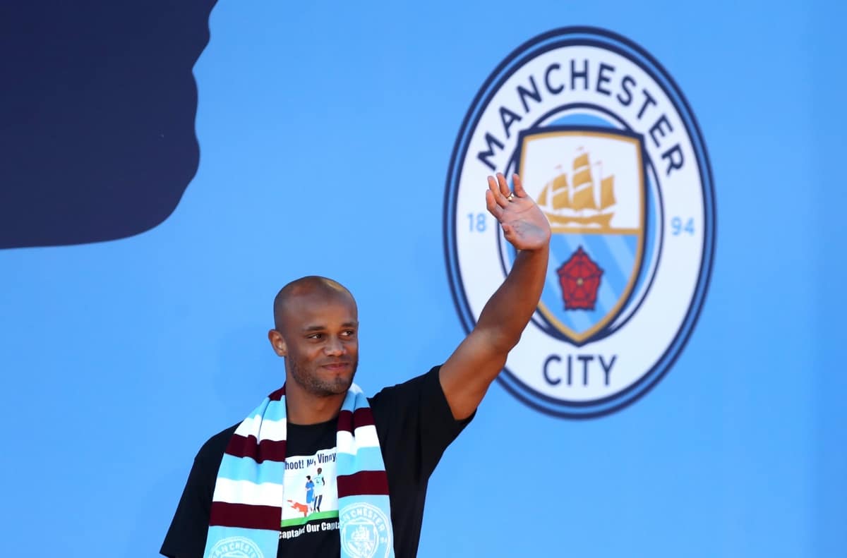 Manchester City's Vincent Kompany waves to fans during the trophy parade in Manchester.