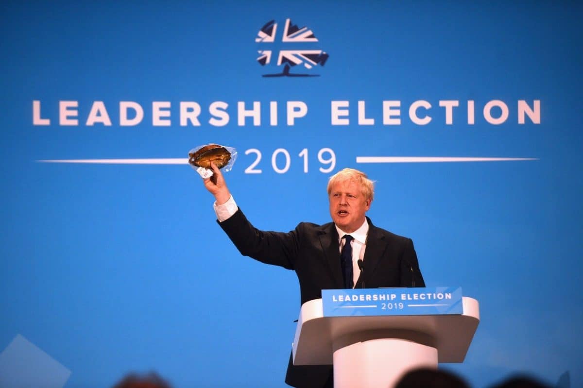 Johnson waves a kipper at Tory leadership hustings to make a point about EU regulations (PA)