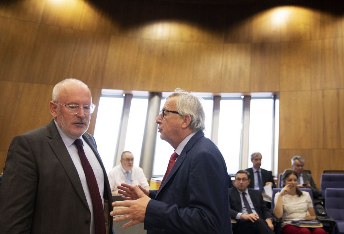 European Commission president Jean-Claude Juncker, right, speaks with Frans Timmermans