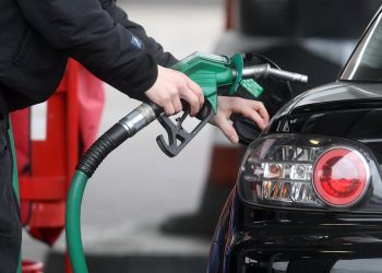 Embargoed to 0001 Wednesday April 03 File photo dated 22/02/13 of a person using a petrol pump. New figures show fuel prices have risen for the second consecutive month.