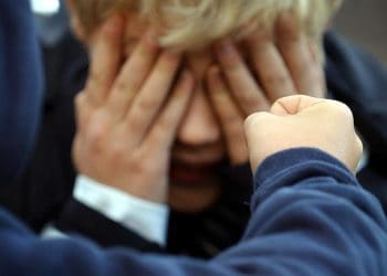 Posed photograph simulating a child being bullied.