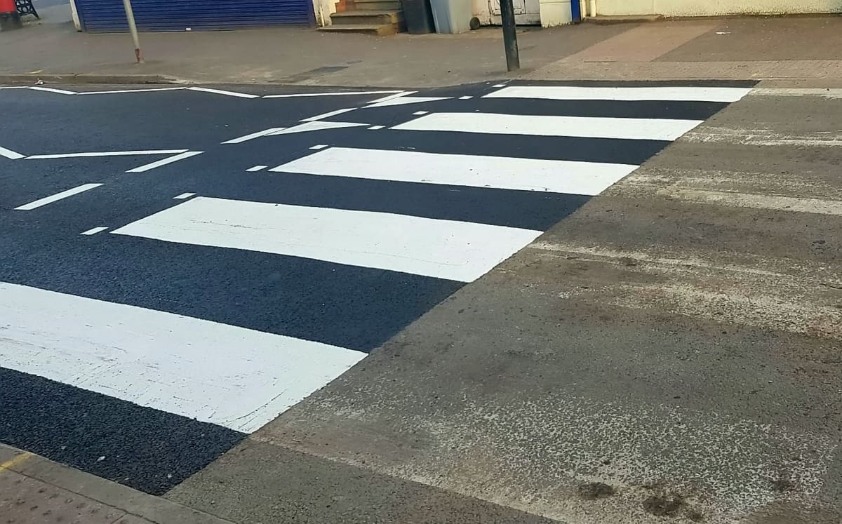 Workmen leave zebra crossing half-painted because of red-tape